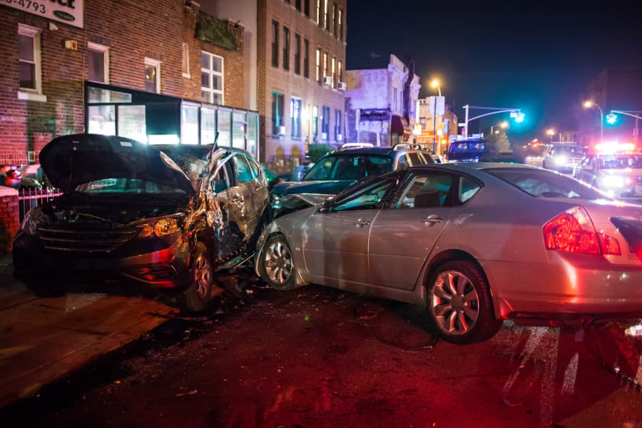 Several heavily damaged vehicles after a collision on a city street