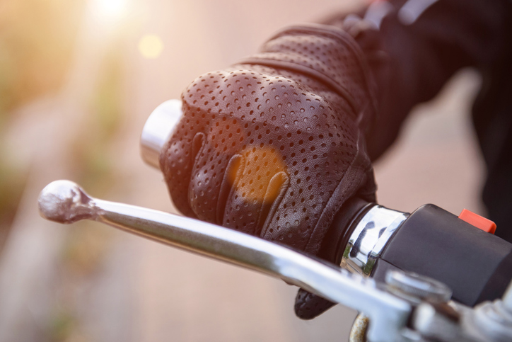 Motorcycle rider's hand on brake 