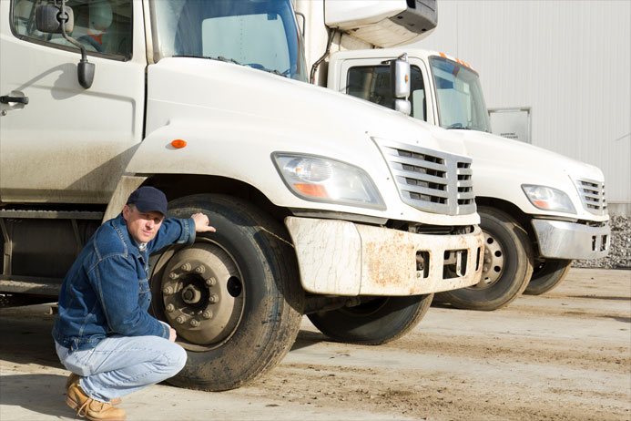 driver inspecting truck