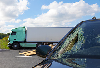 White semi-truck and a silver SUV after a collision