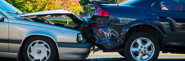 Silver car rear-ending black car