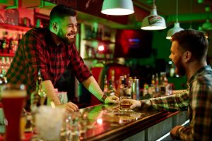 Bartender talking with a patron at the bar counter