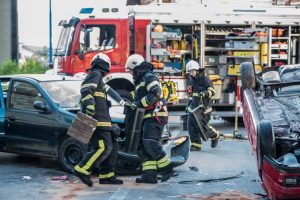 First responders at the scene of an accident with wrecked and flipped cars