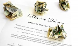 a divorce decree petition and cash laying on a table