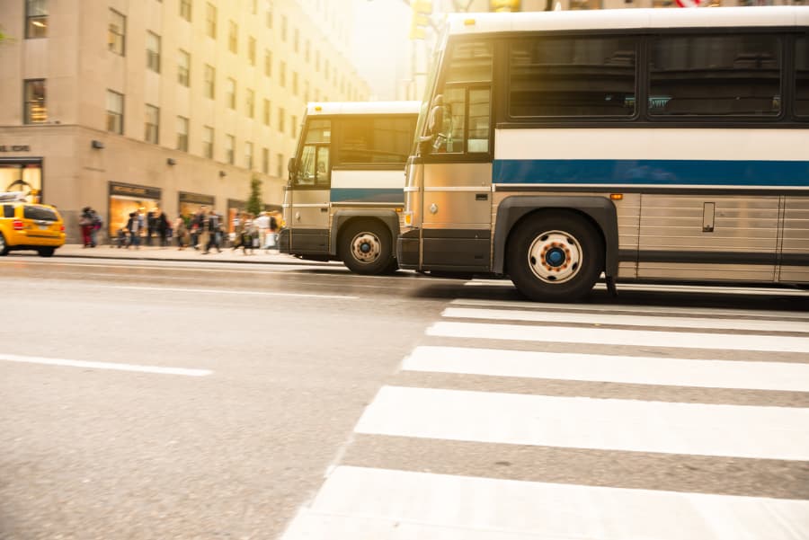 two busses in city traffic