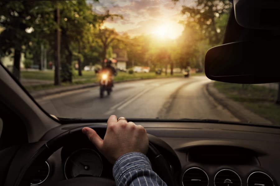 Driver looking ahead and motorcyclist on road