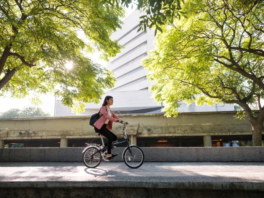 young professional woman riding bike to work