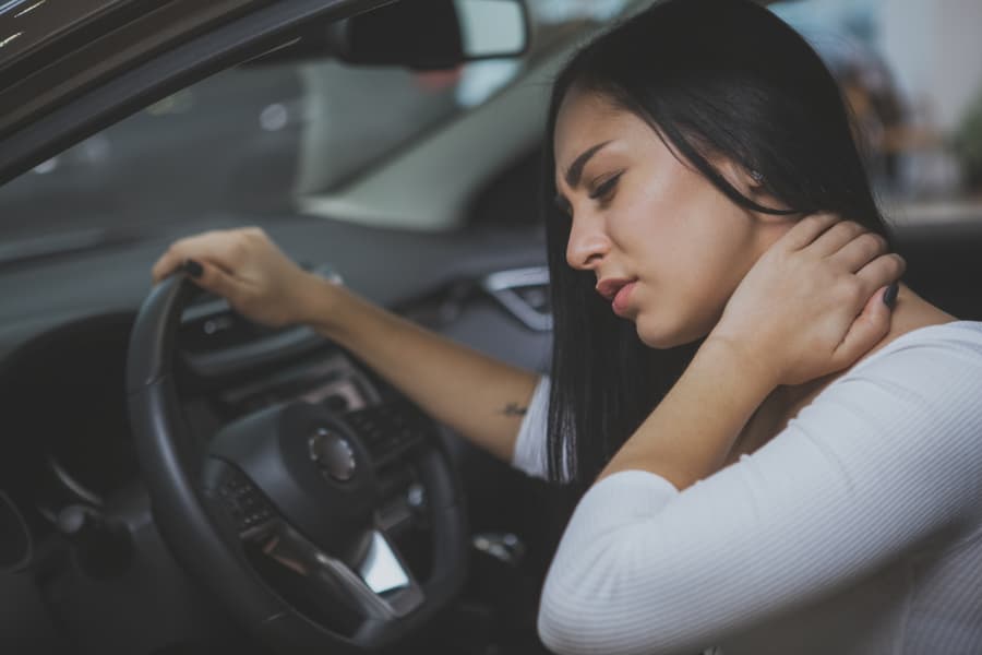Woman holding her neck after a car accident injury
