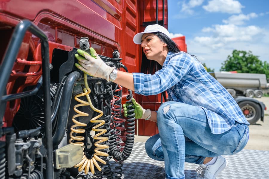 Female driver checking her truck