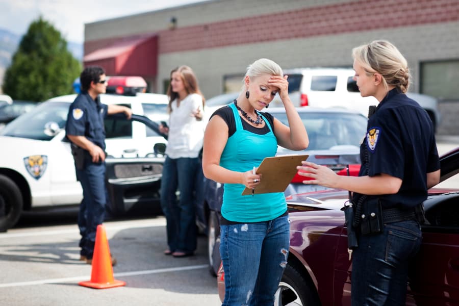 Women speaking to police officers after a car collision