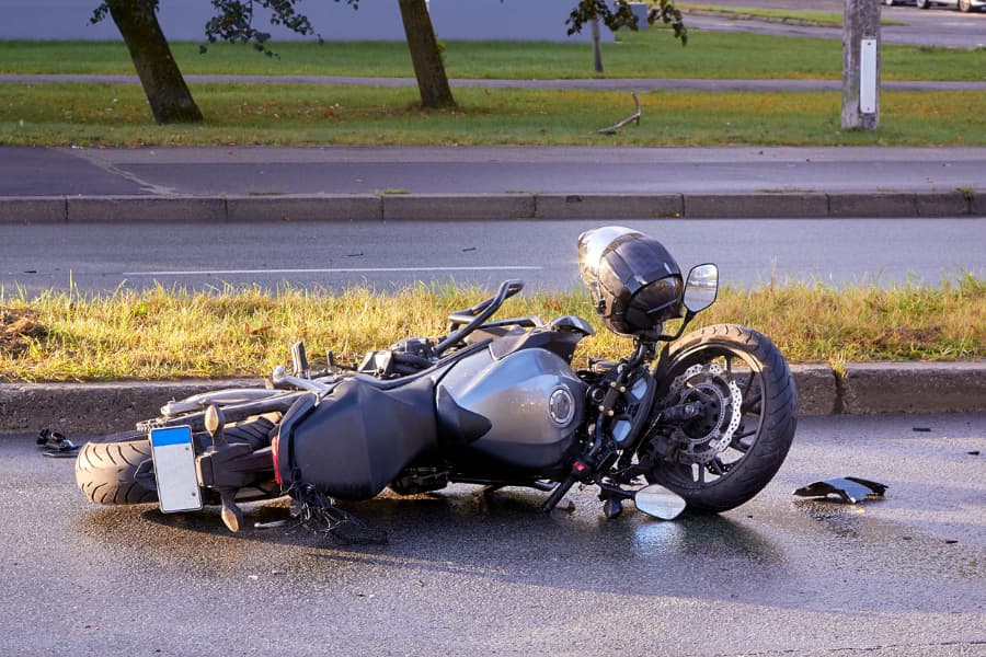 Wrecked motorcycle lying on the road